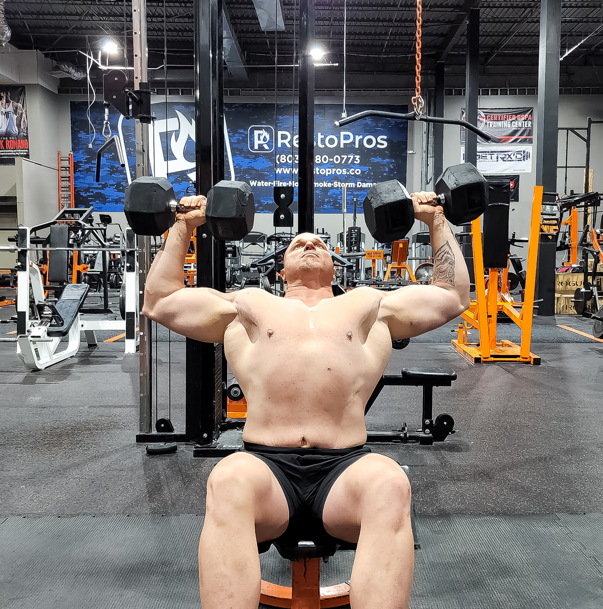 Coach is working with out with dumbbells.
